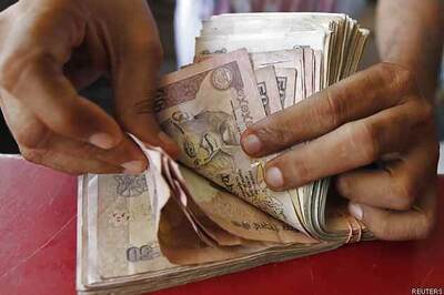 Rupee rallies further 14 paise Vs dollar to end at 61.88