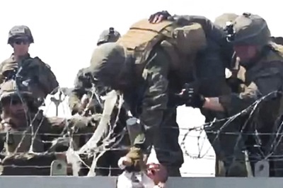 The Story Behind Image of Afghan Baby Being Passed Over Wall at Kabul Airport