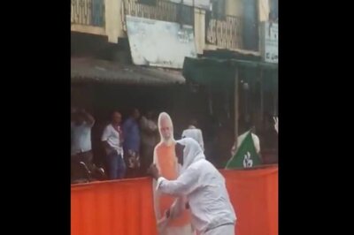 'Modi Ji is God to Me': Man in Karnataka's Devanahalli Seen Cleaning PM's Cut Out Amid Heavy Rains | WATCH
